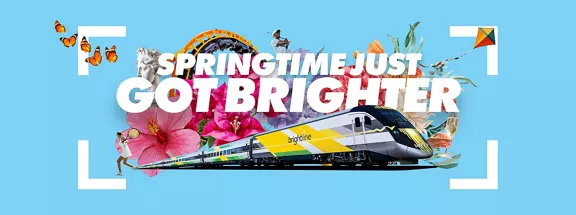 image of a train, flowers on a light blue background with the words Springtime just got brighter 