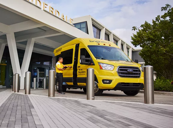 A Brightline shuttle driver parked outside the Fort Lauderdale station.