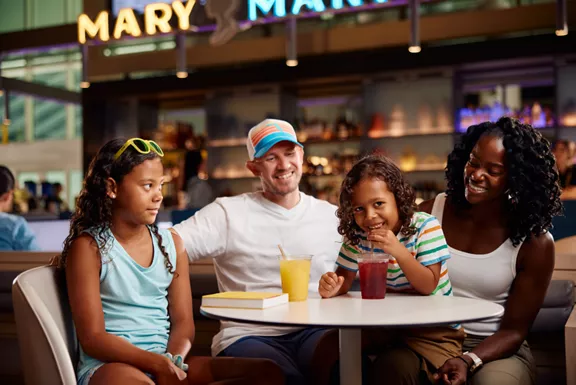 A family enjoying drinks and sodas at the Brightline Mary Mary bar.