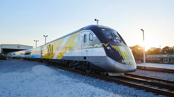 Brightline's Bright Blue train on a railroad