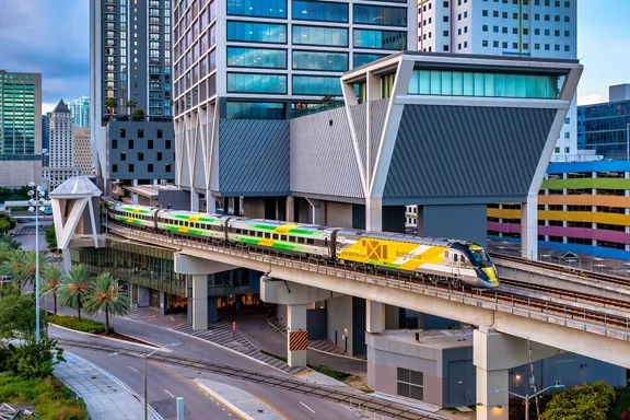 Brightline train leaving the station in the city.