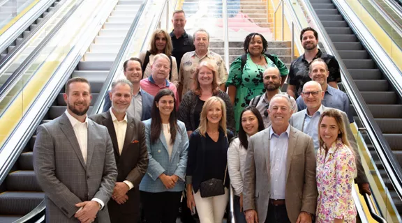Nevada Governor Lombardo with Brightline President Patrick Goddard posing with the Brightline delegation on the stairway in the MiamiCentral station