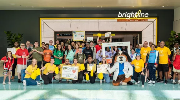 A group photo of Special Olympics Florida children and families, Brightline employees, and sponsors from Orlando Health.