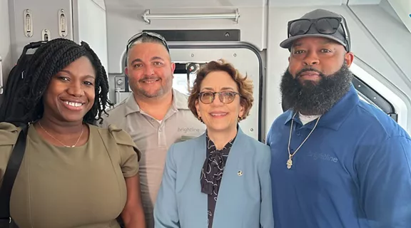  Marjorie Hilaire Chouloute from the FRA, USDOT Deputy Secretary Polly Trottenberg, and Brightline conductor and engineer.