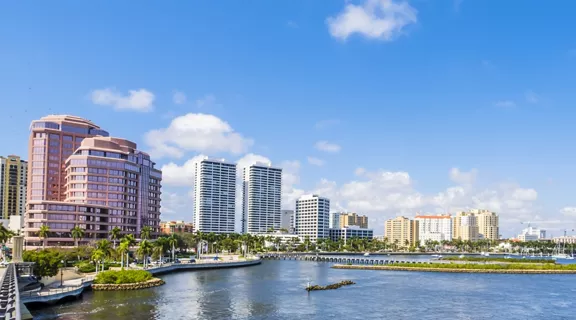 Waterfront view of West Palm Beach skyline on a bright sunny day.