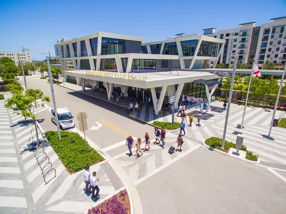 Exterior of West Palm Beach station with people walking around