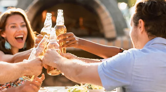 Friends sharing a toast at an outdoor dinner.