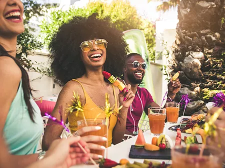 Happy woman smiling at the camera having fun with friends outdoor at the restaurant
