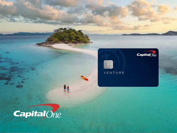 Capital One Venture One card image and logo over an island beach scene in the ocean.