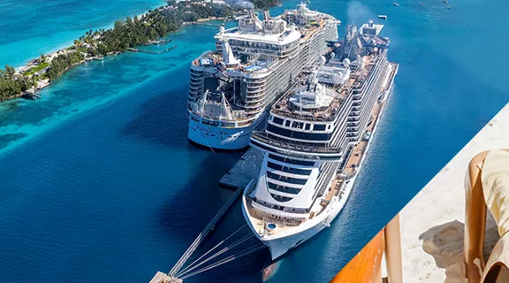 Guests walking toward a docked cruise ship with crystal blue water on either side of runway
