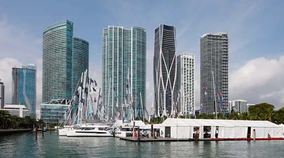 Upscale boats moored in a marina with the Miami skyline in the background