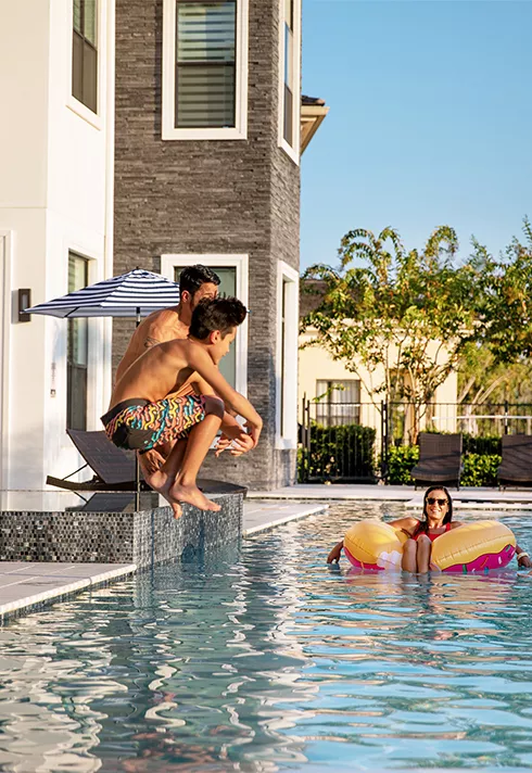 family in and by the side of the pool