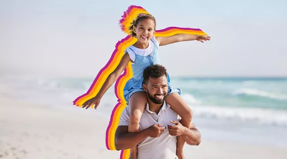 daughter and father enjoying a walk on the beach