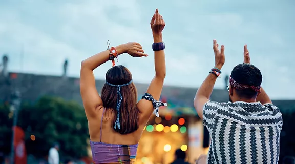 Two people dancing at an outside concert festival