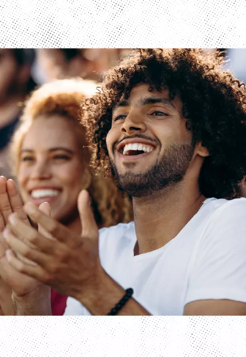 A sports fan clapping and cheering.