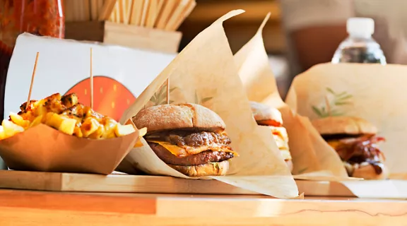 Burgers and fries on a restaurant table.