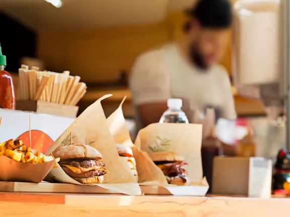 Burgers and fries on a restaurant table.