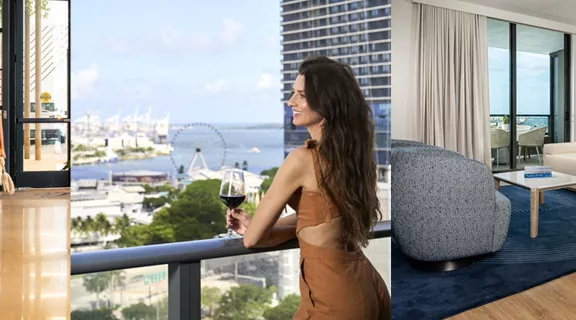 A young man and woman walking their dog through a hotel lobby. A woman standing on a balcony overlooking the ocean, drinking a glass of red wine. Interior of a stylish resort suite.