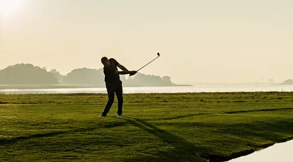 A man playing golf in a golf course