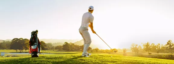 A man playing golf in a beautiful morning at the golf club