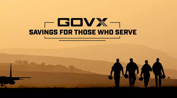 Military service members walking past an aircraft with the caption "GOVX - Savings for Those Who Serve."