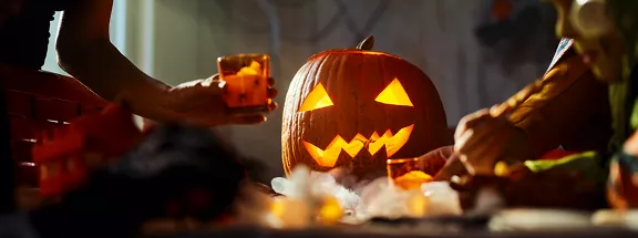 A group of people decorating the pumpkin