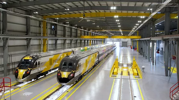 Interior of Brightline Basecamp with two trains parked