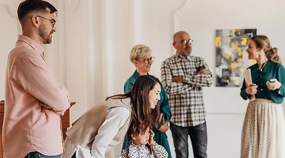 A group of people admiring a painting