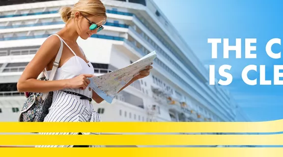 woman with sunglasses looking at amap in front of cruise ship with the words The coast is clear above a train.