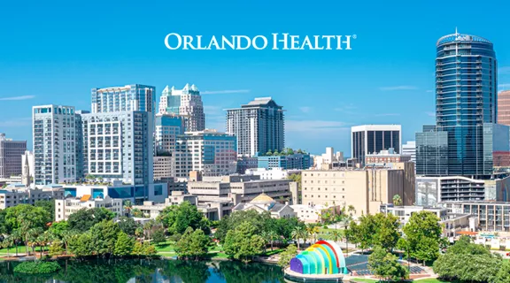 Aerial view of buildings lining Lake Eola in downtown Orlando overlayed with the Orlando Health logo.