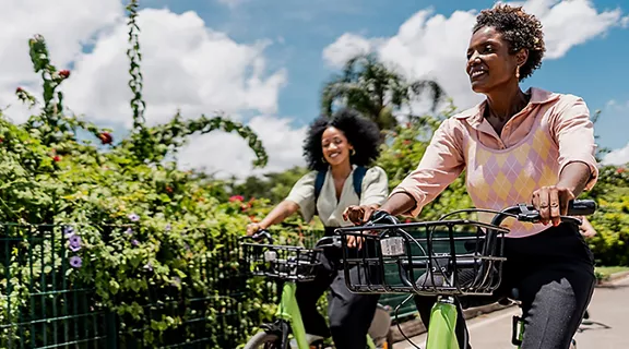 Coworkers riding a bicycle at public park