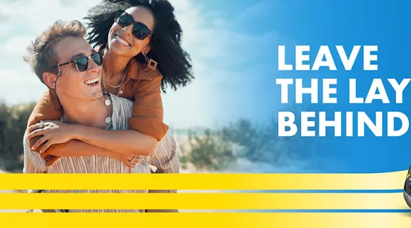 couple in sunglasses withthe words leave the layers behind above a train image