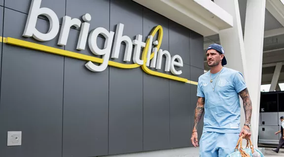 Inter Miami CF player Rodrigo De Paul walking outside of a Brightline station