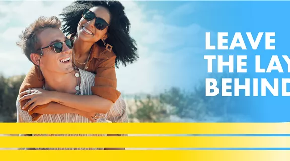 couple with sunglasses smiling with words Leave the layers behind above a image of a train