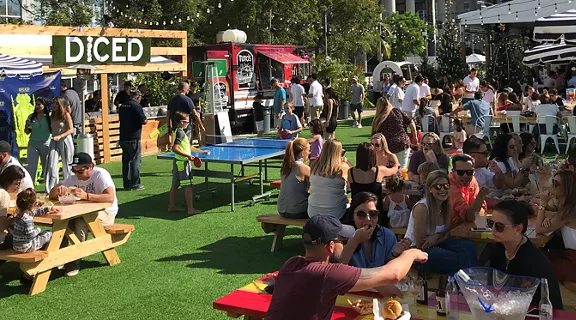 Picnic tables and vendors outside at Smorgasburg Miami.