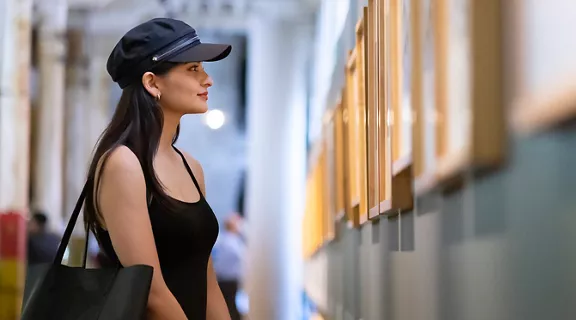 Young woman appreciating works of art in the museum
