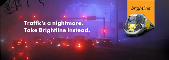 A traffic jam at an intersection on a dark, foggy night.