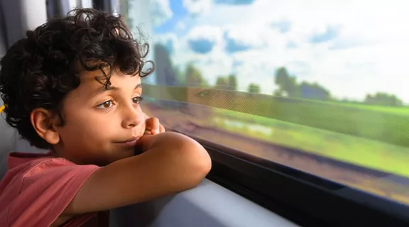 Woman on train reading a book.