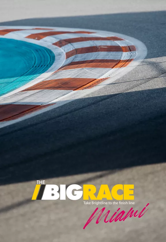A close-up view of a race track curve features bold orange and white markings. The image includes the text 'THE BIG RACE' in large yellow and white letters, with 'Take Brightline to the finish line' and 'Miami' in pink script below.