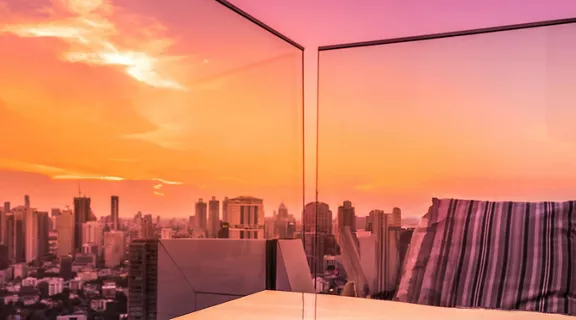 Sunset view of a city from a rooftop.