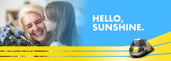 lady holding flowers getting a kiss on the cheek from young girl