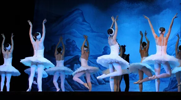 Ballet dancers performing on stage.