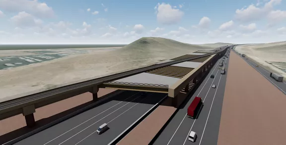 A rendering of elevated Brightline West track over an interstate.