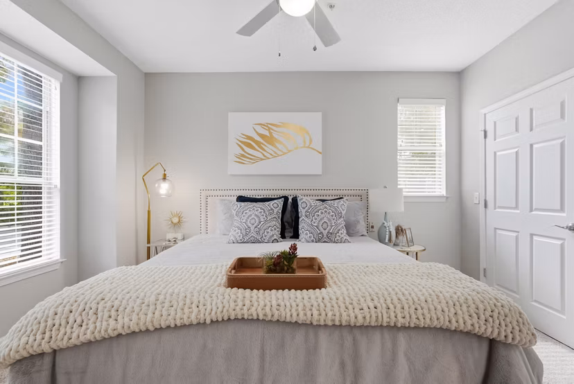 Bedroom featuring modern decor and ample natural light at Avana Long Point Apartments