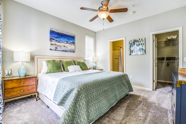 Bedroom featuring modern decor and ample natural light at Avana Long Point Apartments