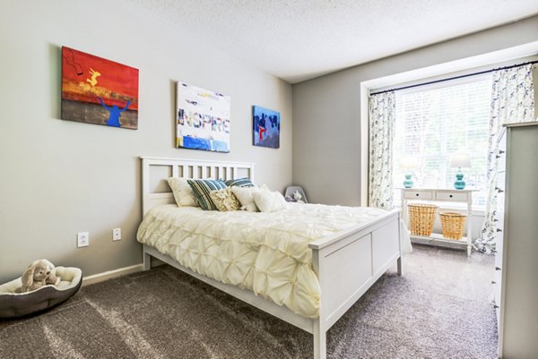 Spacious bedroom with modern decor at Avana Long Point Apartments, a luxury living community