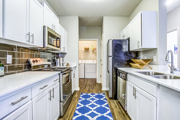Contemporary kitchen with stainless steel appliances in Avana Long Point Apartments luxury housing