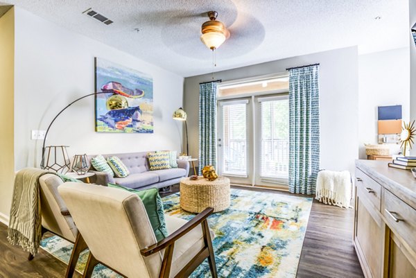Spacious living room with modern decor at Avana Long Point Apartments