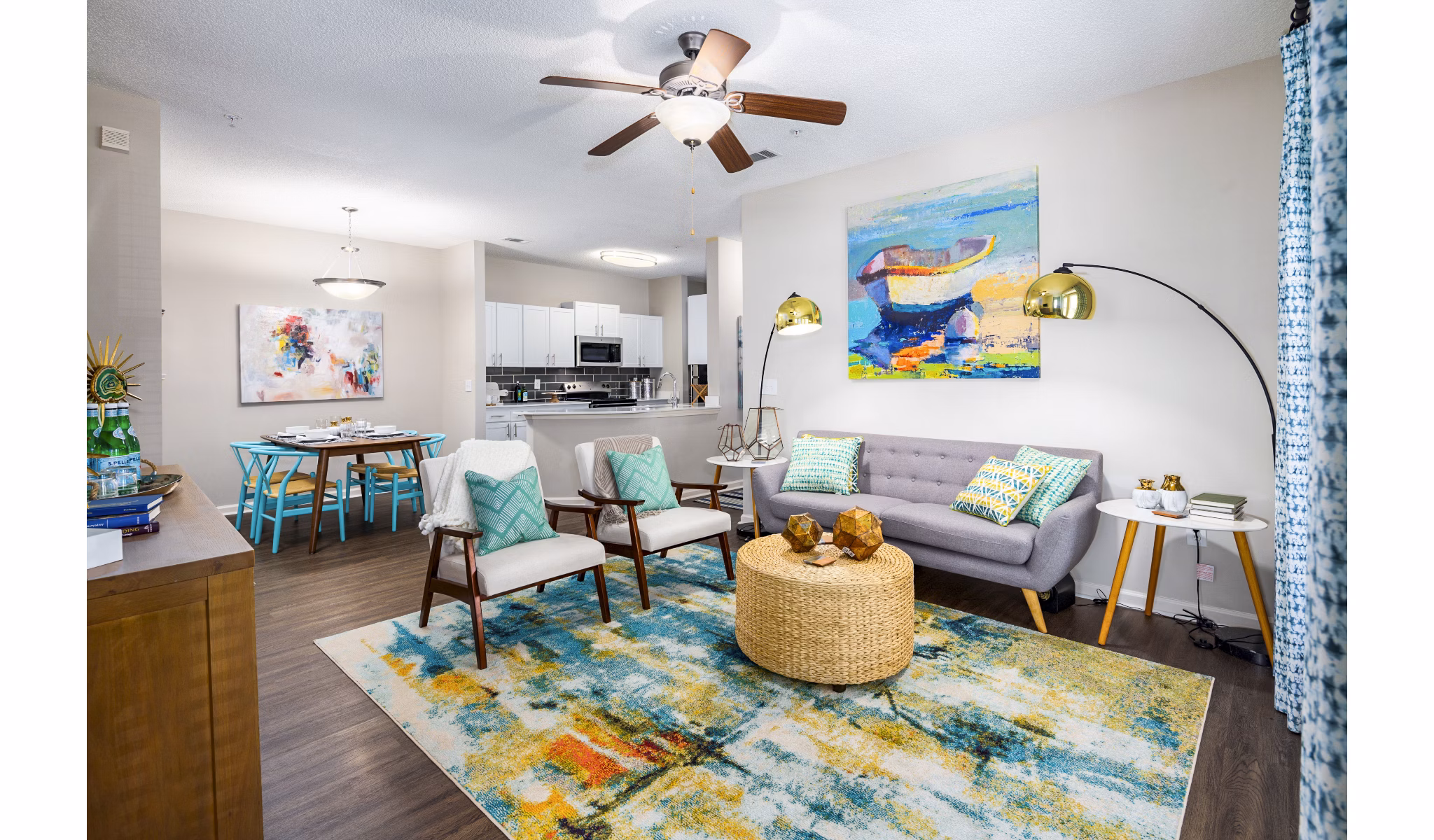 Living room with modern furniture and large windows at Avana Long Point Apartments