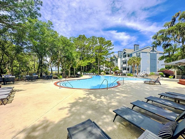Resort-style pool with lounge chairs at Avana Long Point Apartments